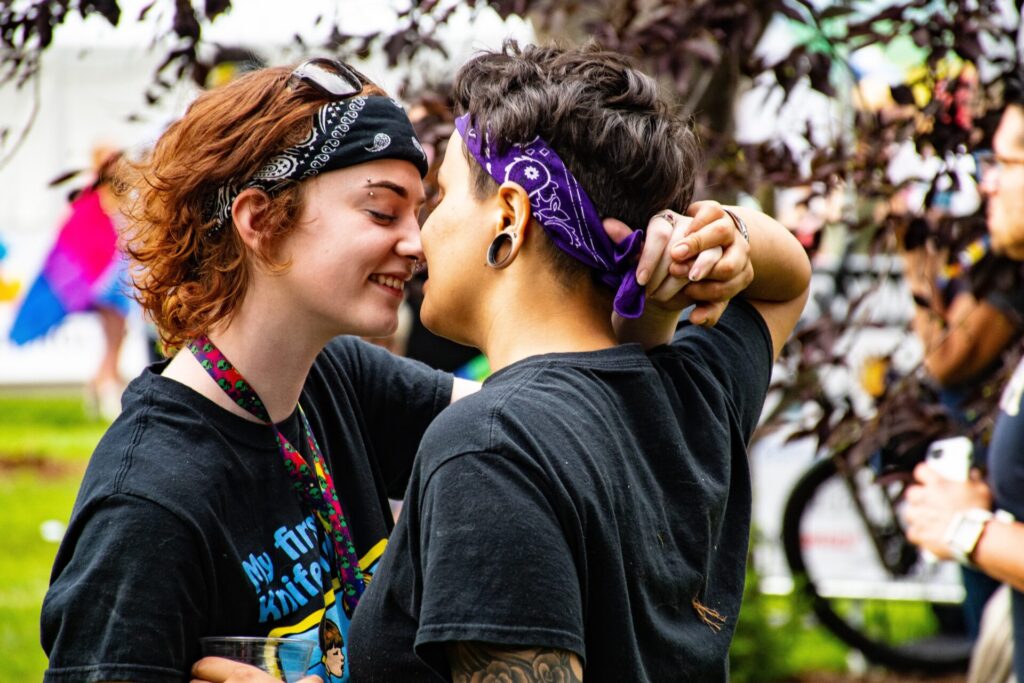 Two girls kissing.