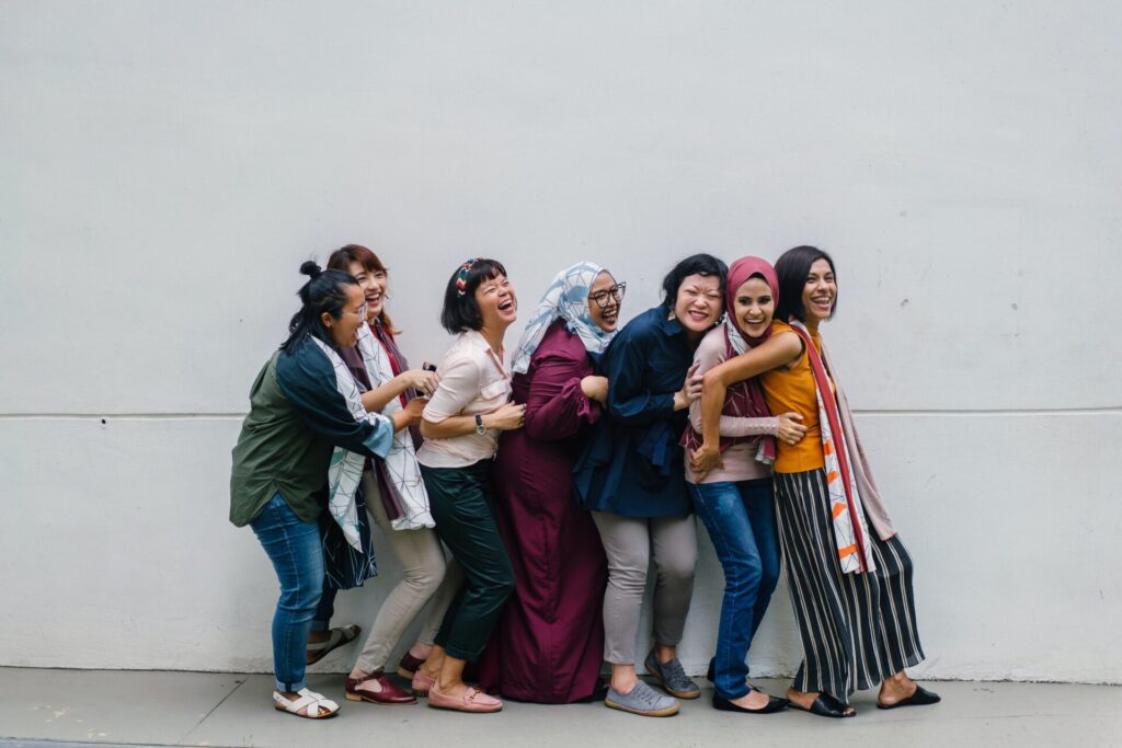 Line of multicultural women standing in a conga line.